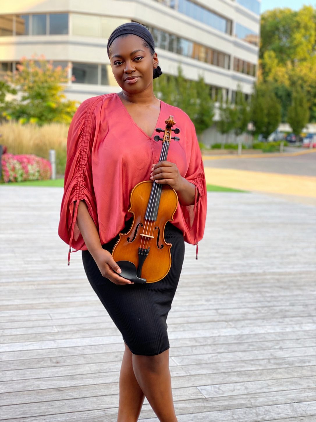 Maya Brown holding her viola outdoors